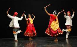 Bhangra dancers in vibrant Punjabi attire performing at wedding